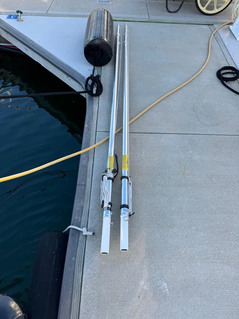 Slide: The Image of Fishing rods on a dock beside a 2011 Rampage 34 IPS boat. - 51