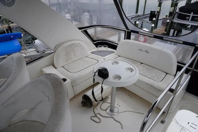 Slide: The Image of 2007 Sea Ray 36 Sedan Bridge interior with seating and table on deck. - 15