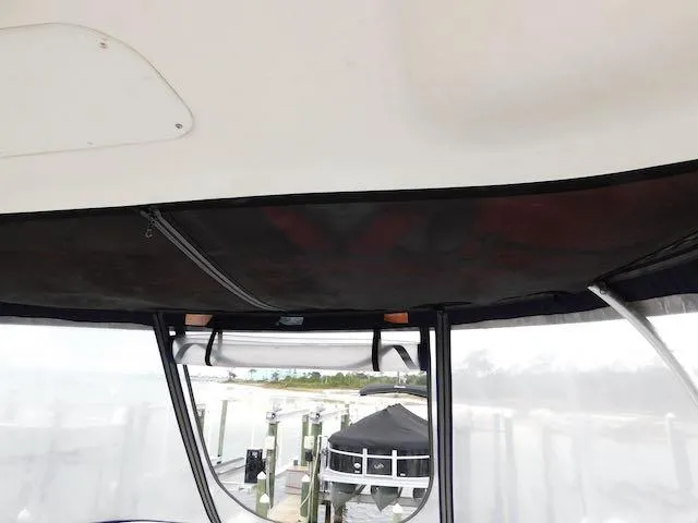 Slide: The Image of 2007 Sea Ray 36 Sedan Bridge interior view with marina background. - 21