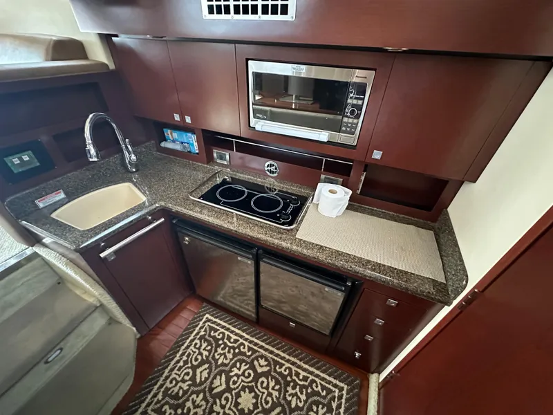 Slide: The Image of Luxurious 2007 Sea Ray 36 Sedan Bridge kitchen with modern appliances and elegant cabinetry. - 22