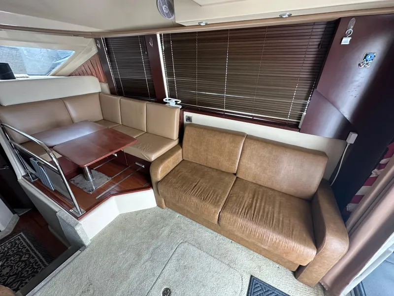 Slide: The Image of Luxurious 2007 Sea Ray 36 Sedan Bridge interior with leather seating and wooden accents. - 28