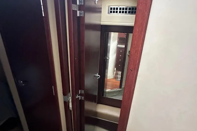Slide: The Image of Interior of 2007 Sea Ray 36 Sedan Bridge with wooden cabinetry and mirror. - 34