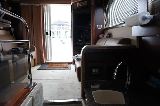 Slide: The Image of Interior of 2007 Sea Ray 36 Sedan Bridge yacht, featuring seating and kitchenette. - 37