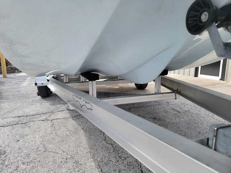 Slide: The Image of 2025 Shallow Sport 18 Sport boat on trailer, close-up view. - 16