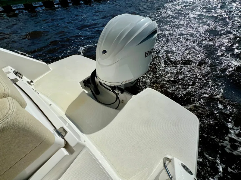 Slide: The Image of 2023 Regal 26 XO boat with Yamaha outboard engine on water. - 12