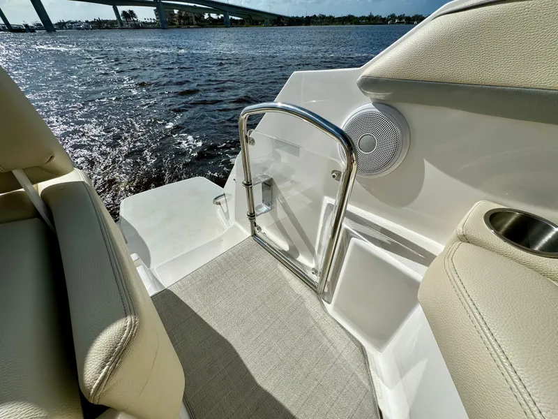Slide: The Image of 2023 Regal 26 XO boat interior with water view, featuring seating and speaker. - 14