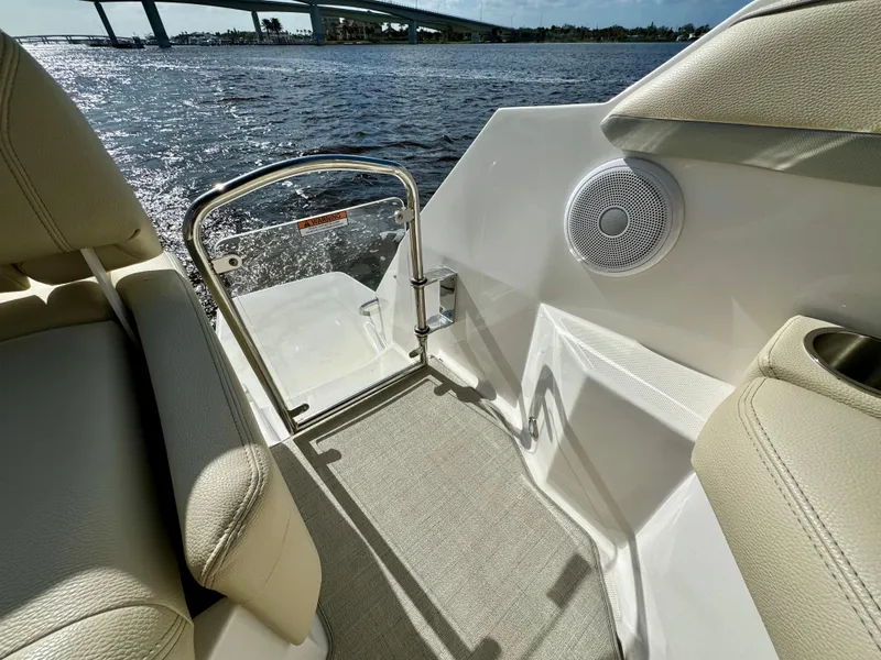 Slide: The Image of 2023 Regal 26 XO boat interior with speaker, seating, and water view. - 15
