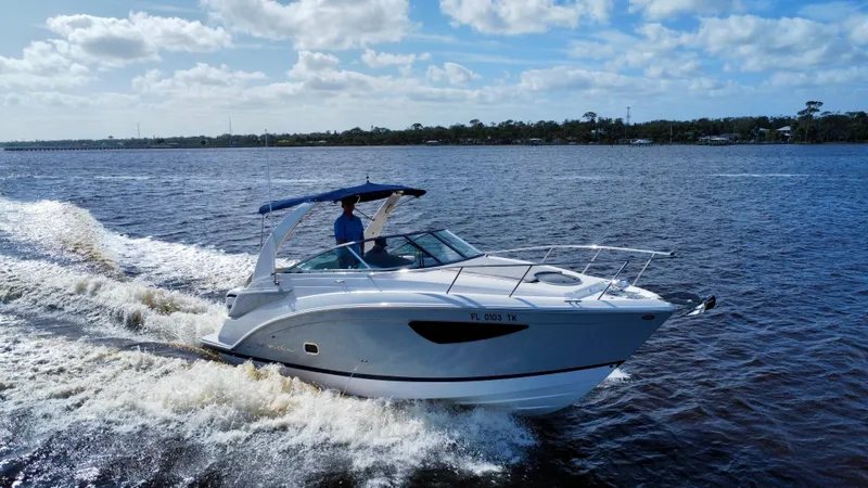 Slide: The Image of 2023 Regal 26 XO boat cruising on a sunny day. - 2