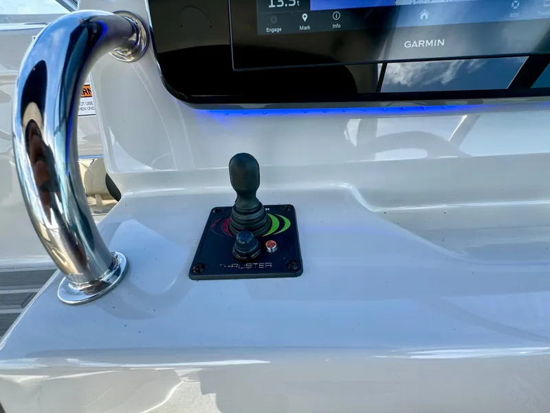 Slide: The Image of 2023 Regal 26 XO boat dashboard with joystick control and Garmin display. - 25