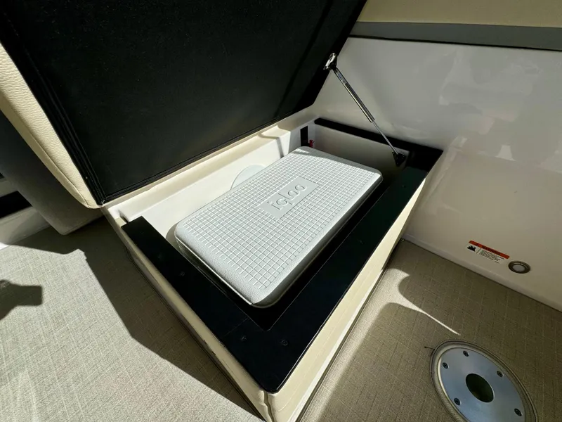 Slide: The Image of 2023 Regal 26 XO boat storage compartment with cooler. - 29
