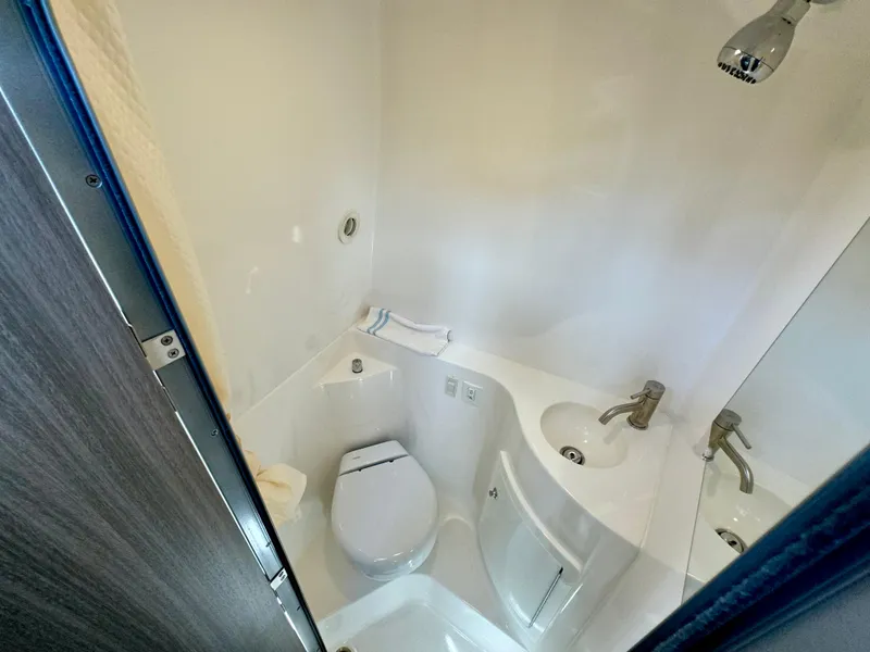 Slide: The Image of 2023 Regal 26 XO boat bathroom with toilet, sink, and shower. - 38