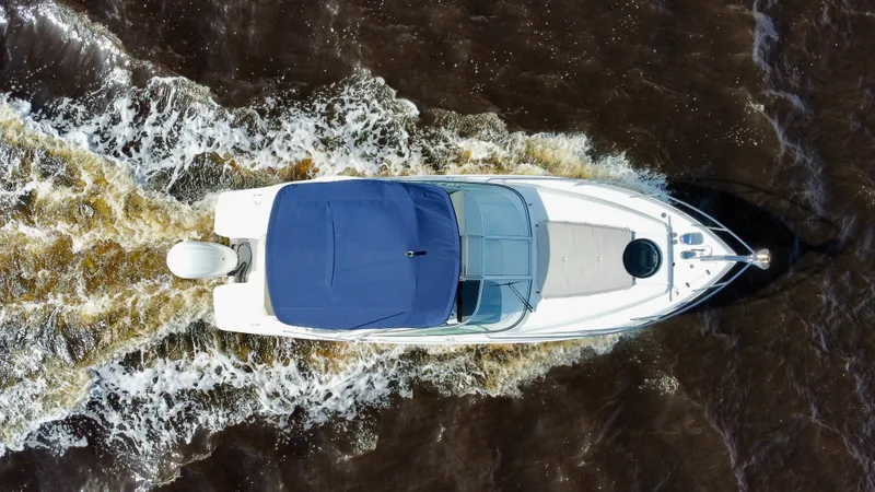 Slide: The Image of Aerial view of 2023 Regal 26 XO boat cruising on water. - 7