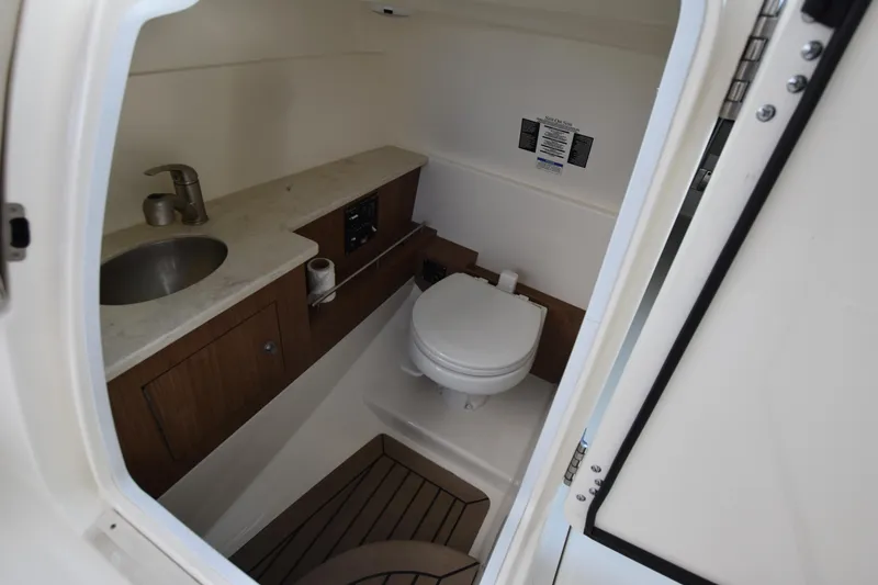 Slide: The Image of 2013 Boston Whaler 270 Vantage boat bathroom with sink and toilet. - 34