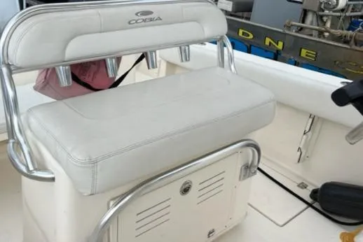 Slide: The Image of 2020 Cobia 237 Center Console boat seating with storage and rod holders. - 10