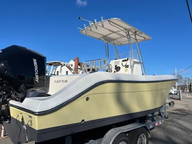 Slide: The Image of 2020 Cobia 237 Center Console boat on trailer, featuring Mercury outboard motor. - 2
