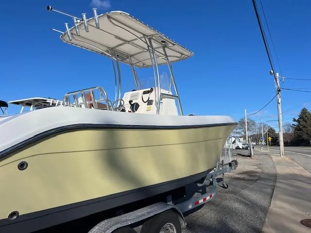 Slide: The Image of 2020 Cobia 237 Center Console boat on trailer under clear blue sky. - 3