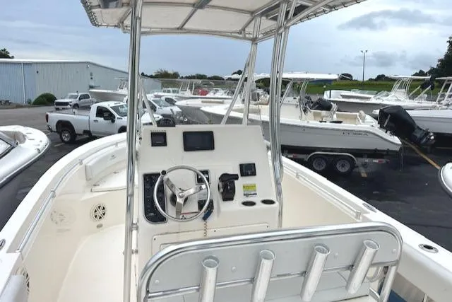 Slide: The Image of 2020 Cobia 237 Center Console boat with steering wheel and navigation equipment. - 4