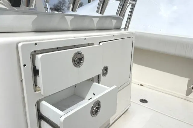 Slide: The Image of 2020 Cobia 237 Center Console boat storage compartments with open drawers. - 6