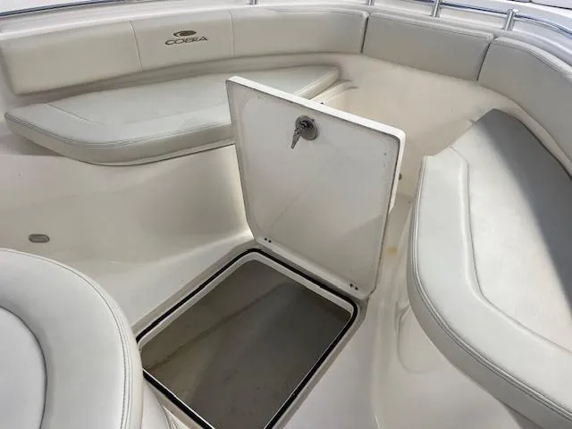 Slide: The Image of 2020 Cobia 237 Center Console boat interior with storage compartment open. - 8
