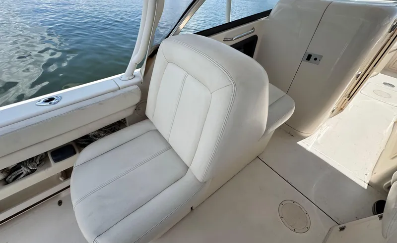 Slide: The Image of 2016 Grady-White Freedom 285 boat interior with white seating and water view. - 17
