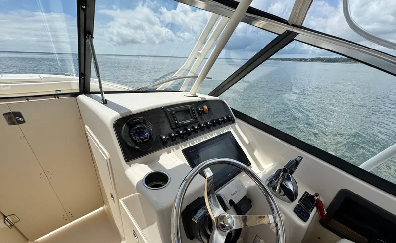 Slide: The Image of 2016 Grady-White Freedom 285 boat helm with ocean view. - 22