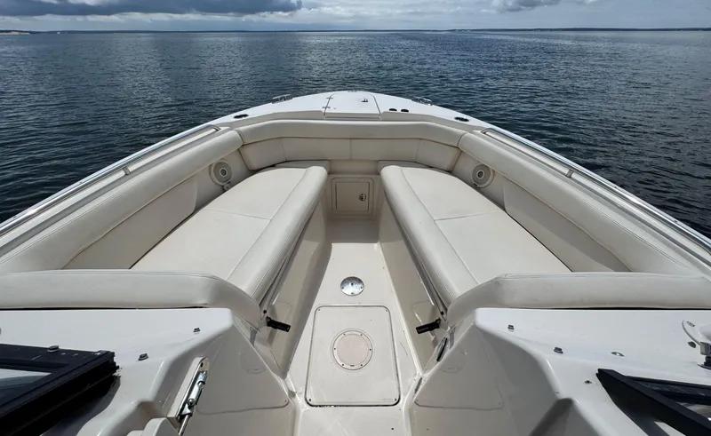 Slide: The Image of 2016 Grady-White Freedom 285 boat interior with spacious seating on calm water. - 24