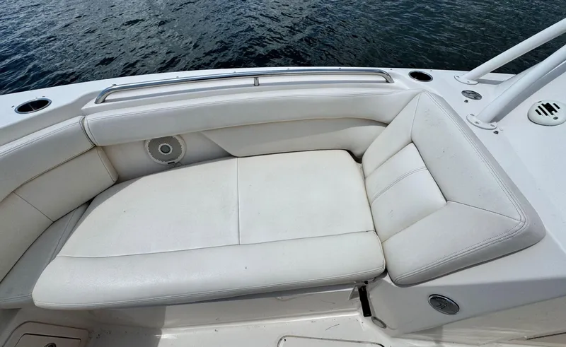 Slide: The Image of White cushioned seating on 2016 Grady-White Freedom 285 boat, near water. - 25