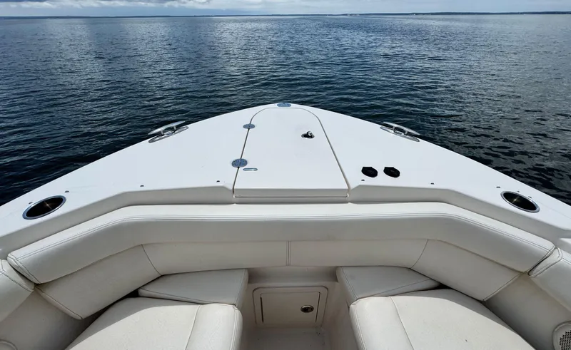 Slide: The Image of 2016 Grady-White Freedom 285 boat bow with seating, overlooking calm water. - 27