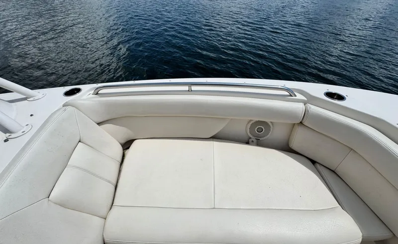 Slide: The Image of 2016 Grady-White Freedom 285 boat with white cushioned seating on calm water. - 29