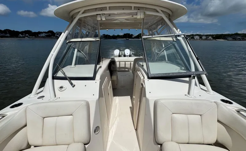 Slide: The Image of 2016 Grady-White Freedom 285 boat on calm water, featuring spacious seating and open cockpit. - 30