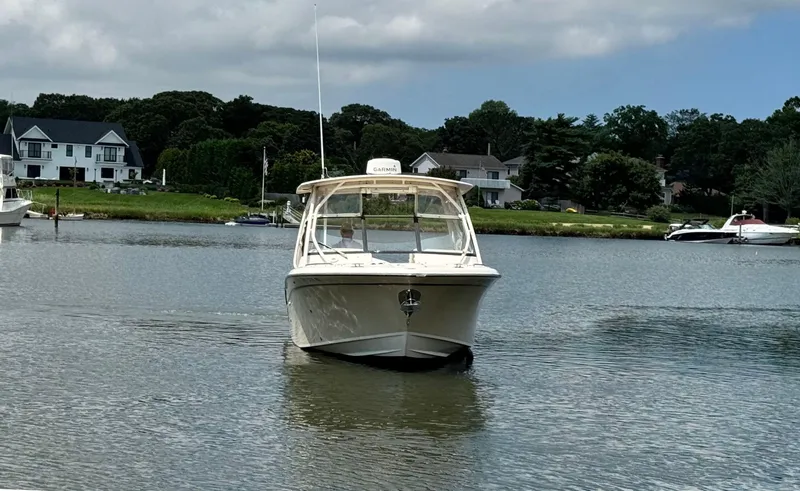 Slide: The Image of 2016 Grady-White Freedom 285 boat on calm water near residential area. - 6