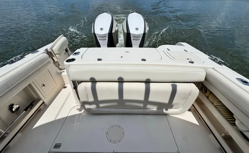 Slide: The Image of 2016 Grady-White Freedom 285 boat with twin Evinrude 250 engines on water. - 8
