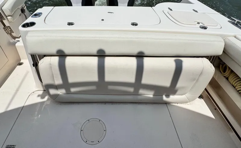 Slide: The Image of 2016 Grady-White Freedom 285 boat interior with white seating and cup holders. - 9