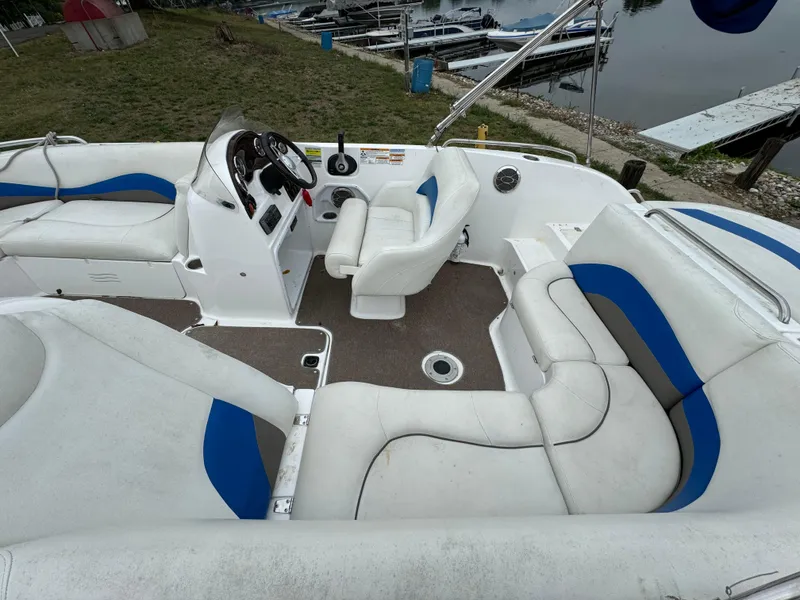 Slide: The Image of 2014 Hurricane SunDeck Sport 202 IO boat interior with white and blue seating. - 2