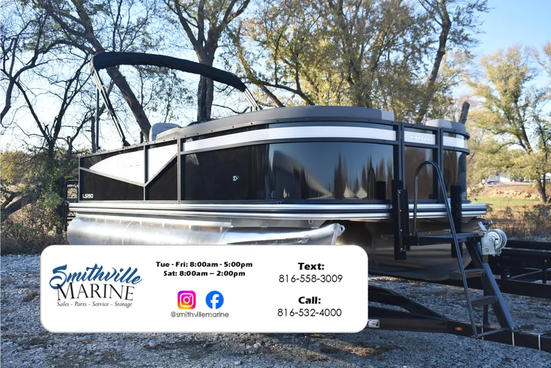 Slide: The Image of 2025 Lowe LS 190 pontoon boat at Smithville Marine dealership, surrounded by trees. - 1
