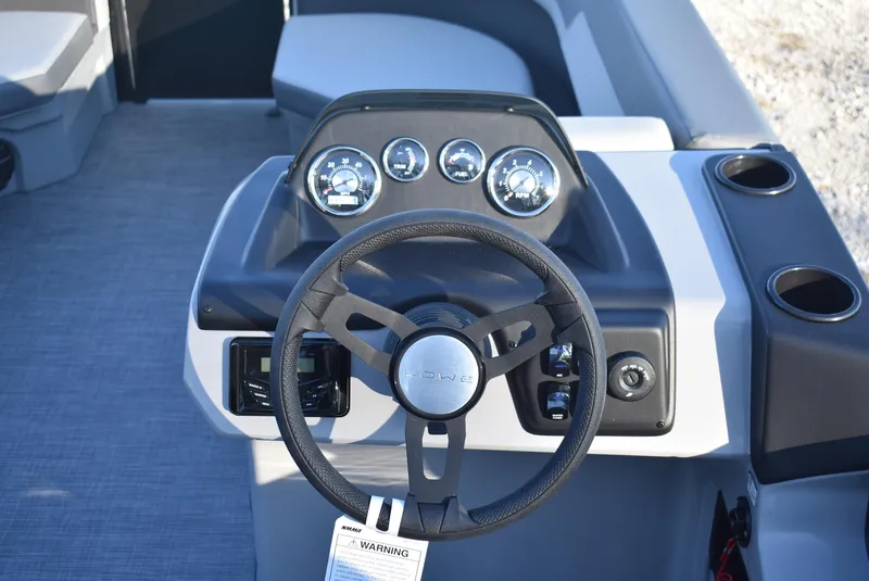 Slide: The Image of 2025 Lowe LS 190 boat dashboard with steering wheel and gauges. - 10