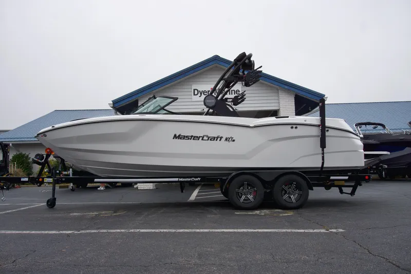 The Image of 2025 MasterCraft NXT23 boat on trailer in front of Dyer Marine building. - 0