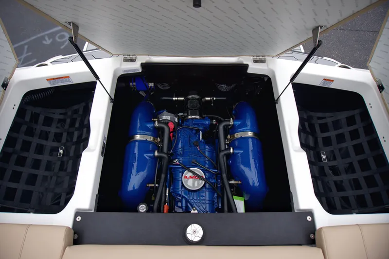 Slide: The Image of 2025 MasterCraft NXT23 boat engine compartment with blue engine components. - 11