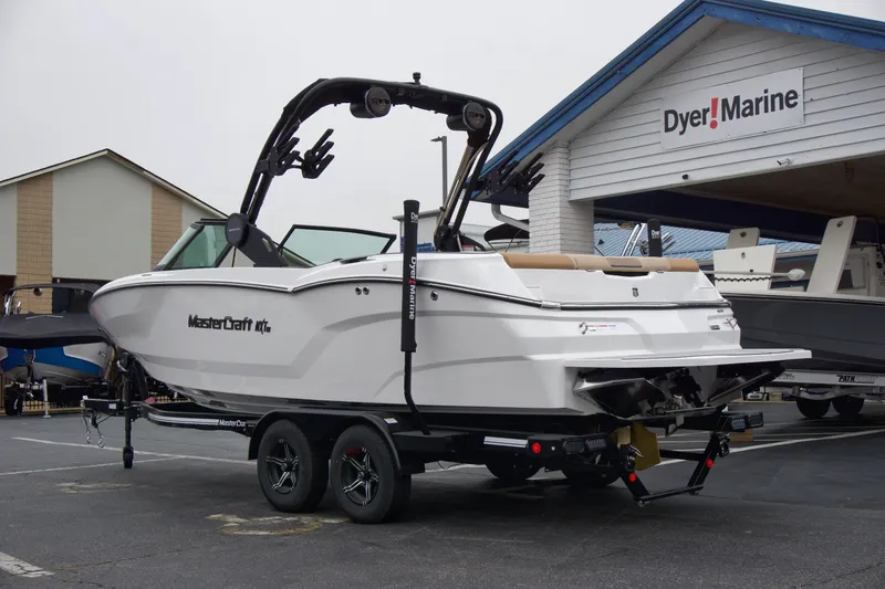 Slide: The Image of 2025 MasterCraft NXT23 boat on trailer at Dyer Marine dealership. - 2