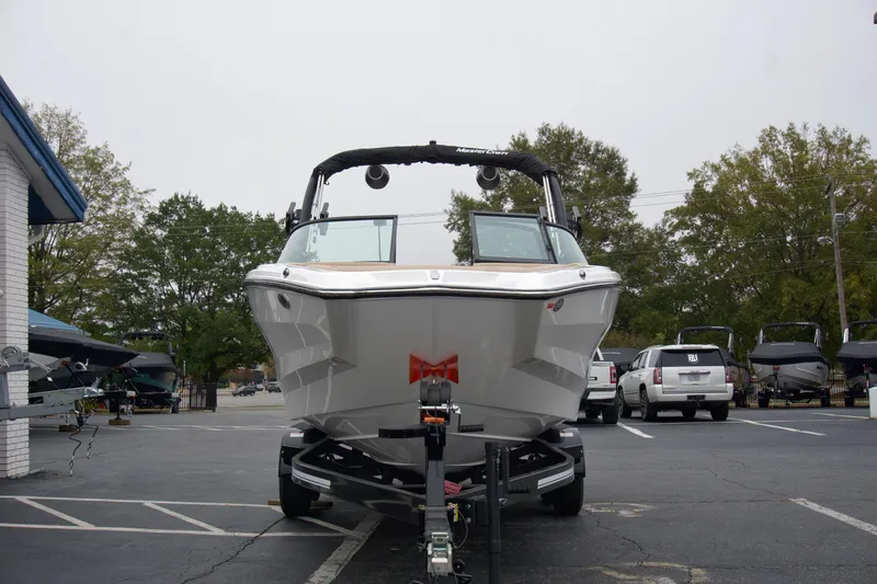 Slide: The Image of 2025 MasterCraft NXT23 boat on trailer in parking lot. - 3