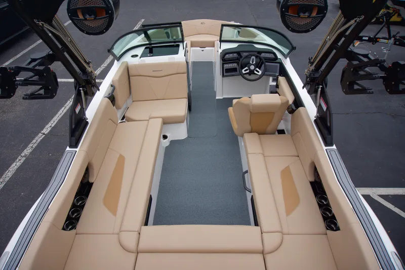 Slide: The Image of 2025 MasterCraft NXT23 boat interior with beige seating and modern dashboard. - 6