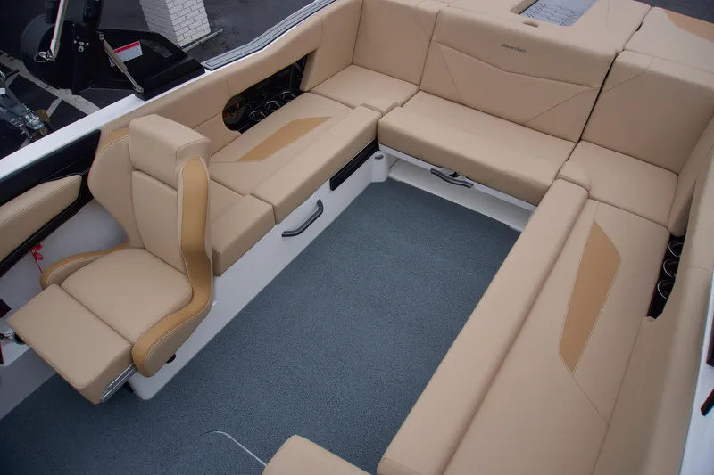 Slide: The Image of 2025 MasterCraft NXT23 boat interior with beige seating and modern design. - 8