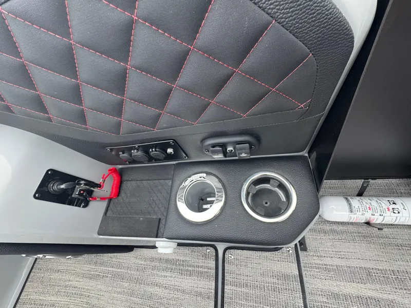 Slide: The Image of Interior of 2025 Godfrey AQUAPATIO 255SFL with cup holders and fire extinguisher. - 15