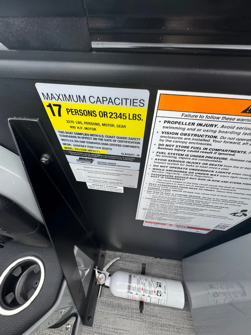 Slide: The Image of Godfrey AQUAPATIO 255SFL 2025 boat capacity label, 17 persons or 2345 lbs, safety warnings. - 16