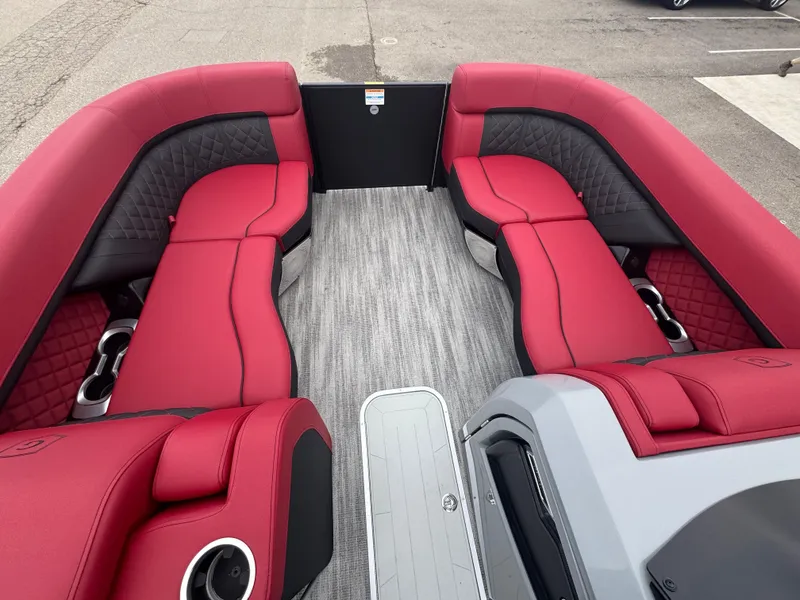Slide: The Image of 2025 Godfrey AQUAPATIO 255SFL boat interior with red and black seating, gray flooring. - 17
