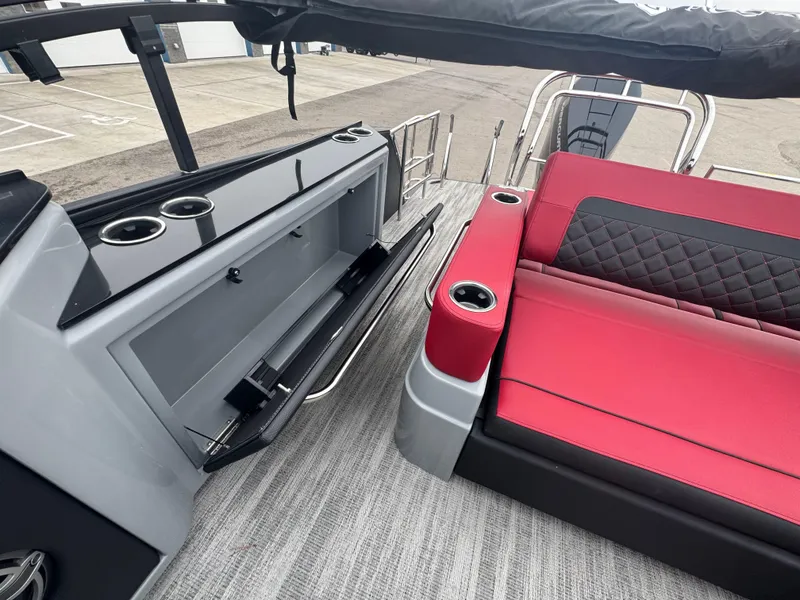 Slide: The Image of 2025 Godfrey AQUAPATIO 255SFL boat interior with red seating and storage compartment. - 24