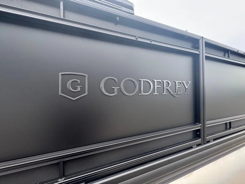 Slide: The Image of Close-up of 2025 Godfrey AQUAPATIO 255SFL logo on black panel. - 6
