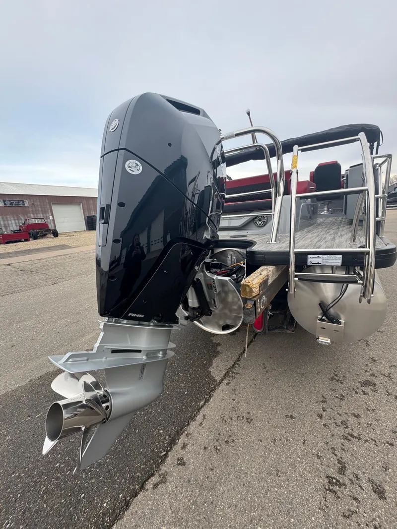 Slide: The Image of 2025 Godfrey AQUAPATIO 255SFL boat with powerful outboard motor on display. - 9