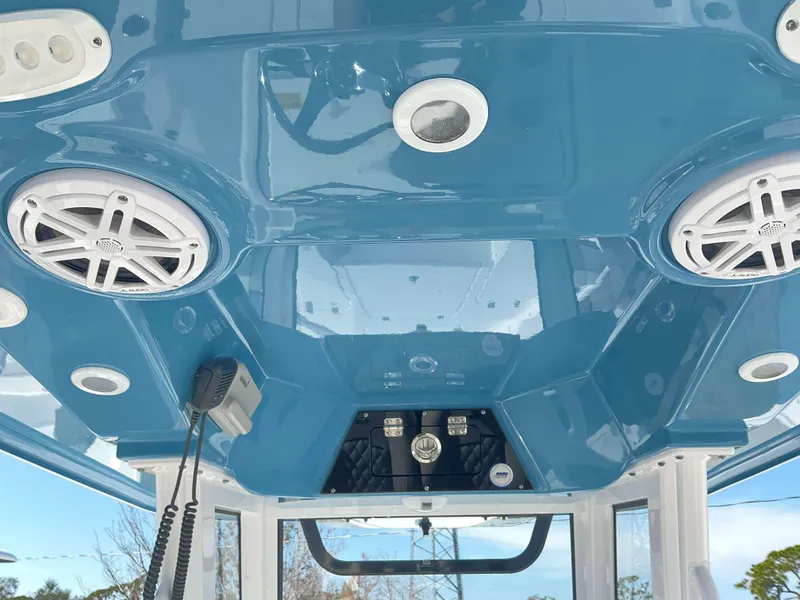Slide: The Image of 2025 Sportsman 247 MASTERS boat interior with blue ceiling, speakers, and radio equipment. - 10