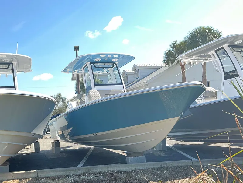 Slide: The Image of 2025 Sportsman 247 MASTERS boat displayed outdoors under clear blue sky. - 12